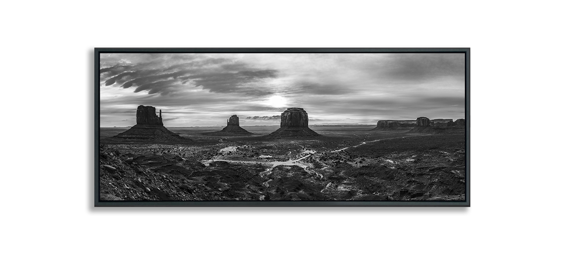 Monument Valley panoramic black and white fine art photograph desert expanse with three classic buttes and more buttes in distance