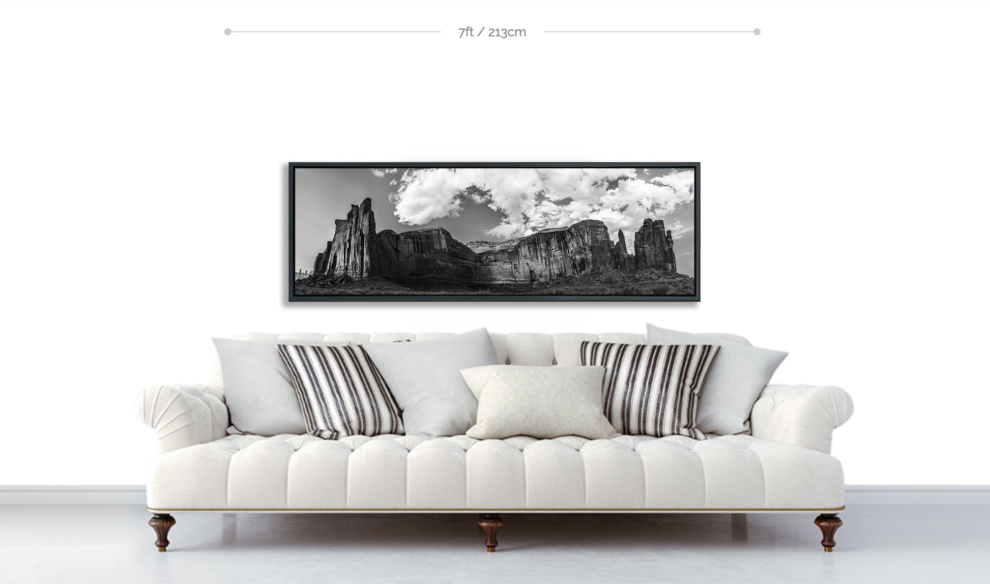 Monument Valley Print black and white hanging on wall above white sofa with pillows