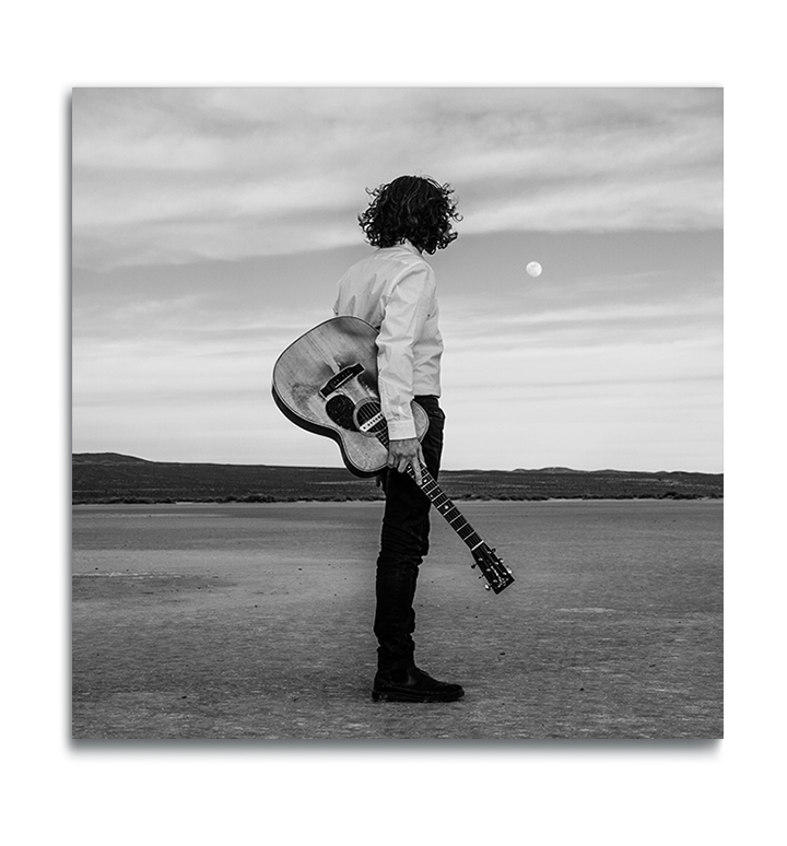 Fine Art Square metal print man standing alone in desert holding Gibson acoustic guitar staring at moon above the horizon in black and white