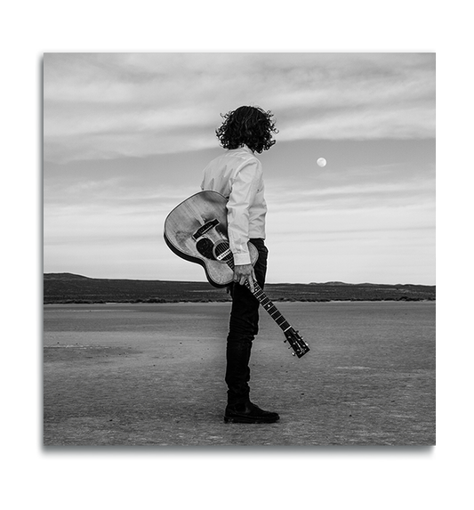 Fine Art Square metal print man standing alone in desert holding Gibson acoustic guitar staring at moon above the horizon in black and white