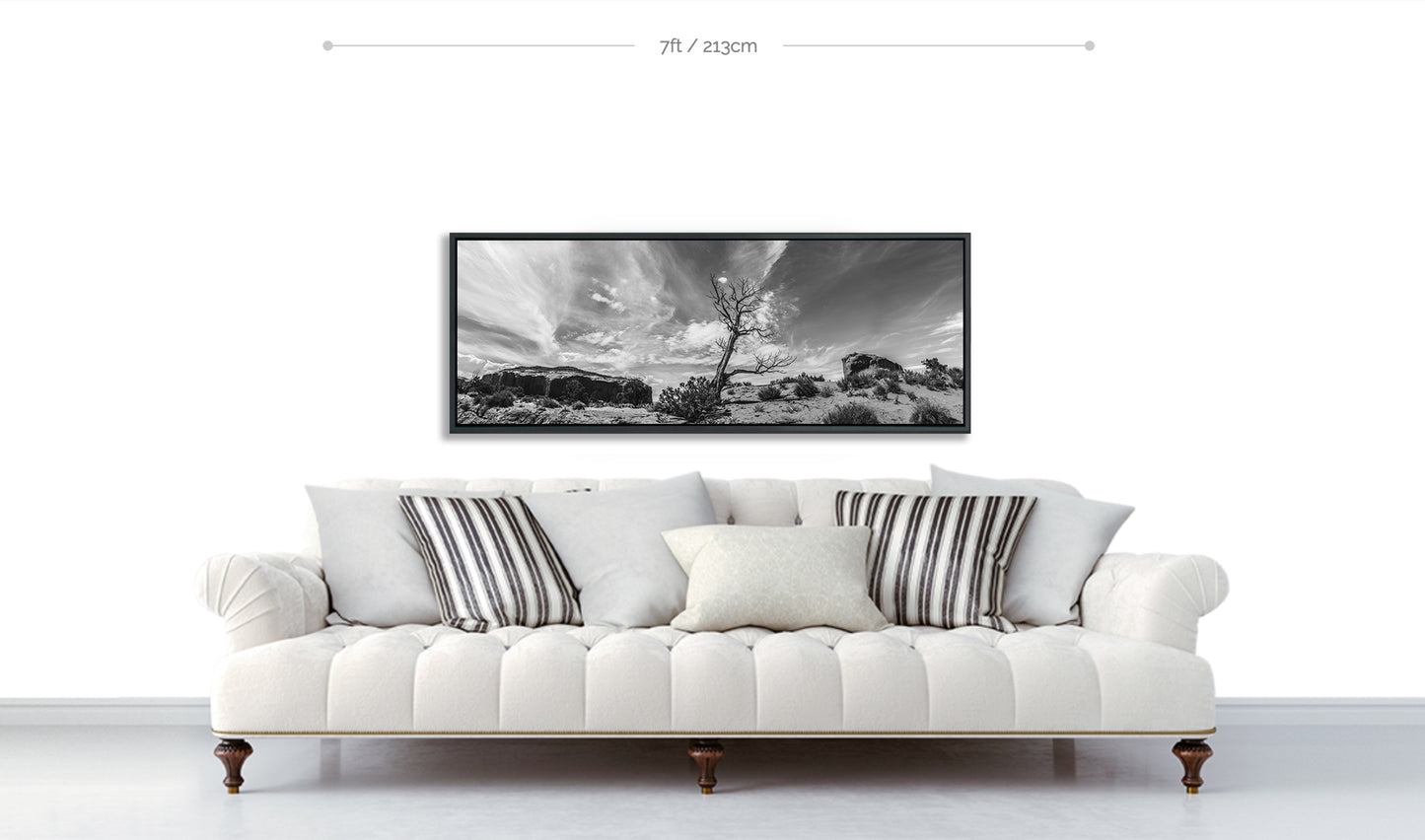 Fine Art Black and White Print Monument Valley dried desert tree displayed hanging on white wall above white sofa with cushions