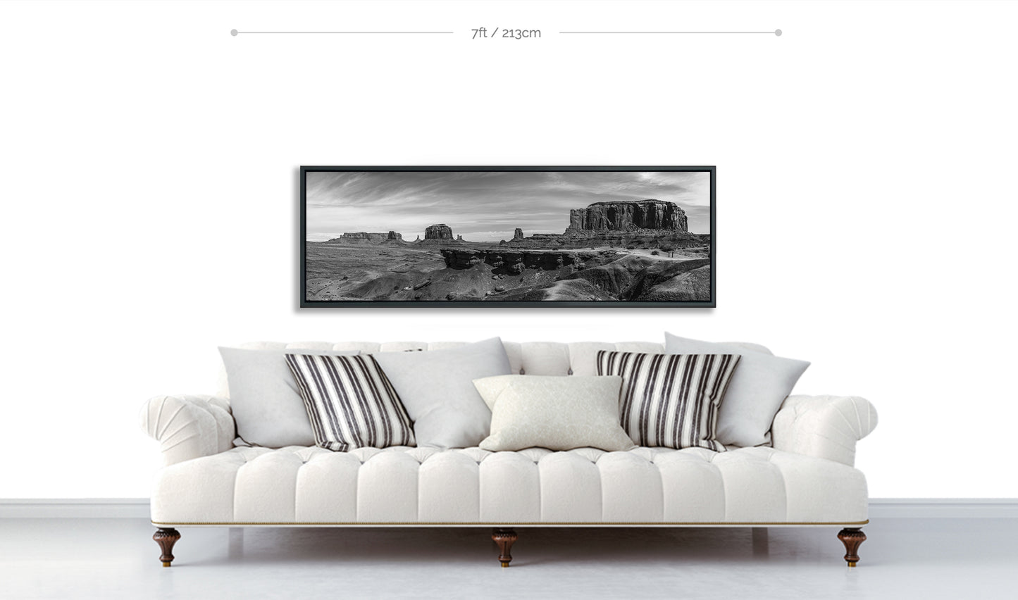 John Ford Point Monument Valley Black and White panoramic Fine Art Print displayed on white way above white sofa with cushions