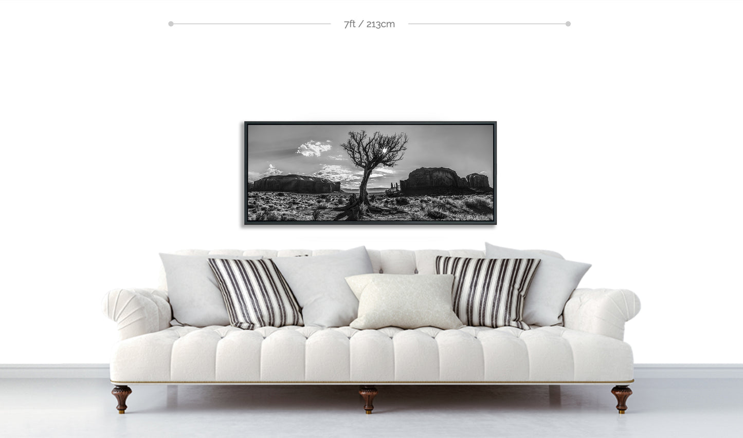 Monument Valley Desert Tree Fine Art Black and White Print displayed on white wall above white sofa with patterned pillows