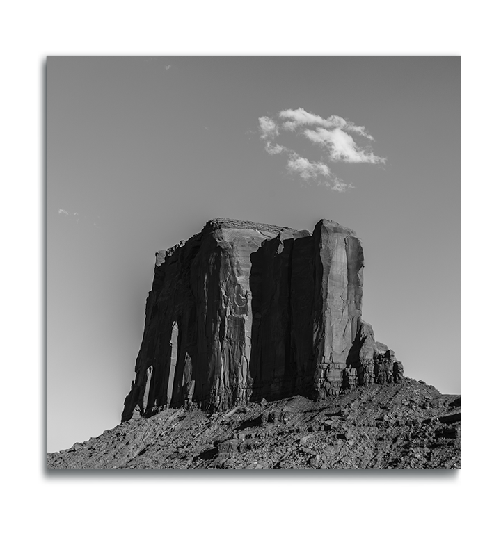 Monumental Valley butte with small patch of clouds above it black and white print on metal