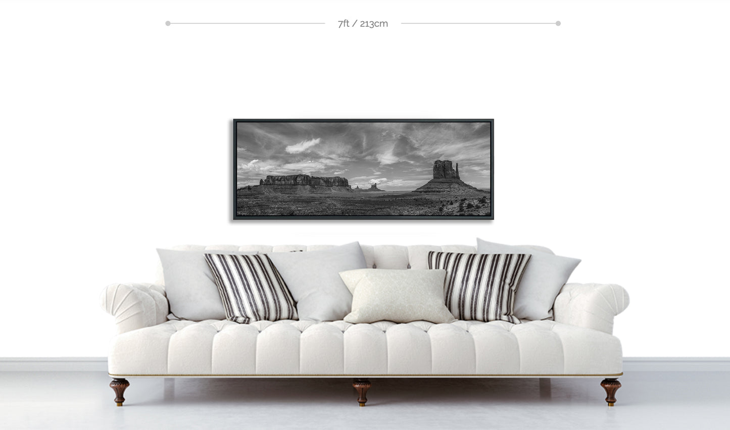 Monument Valley Limited Edition Fine Art Framed Print displayed hanging on white wall above white sofa with patterned cushions