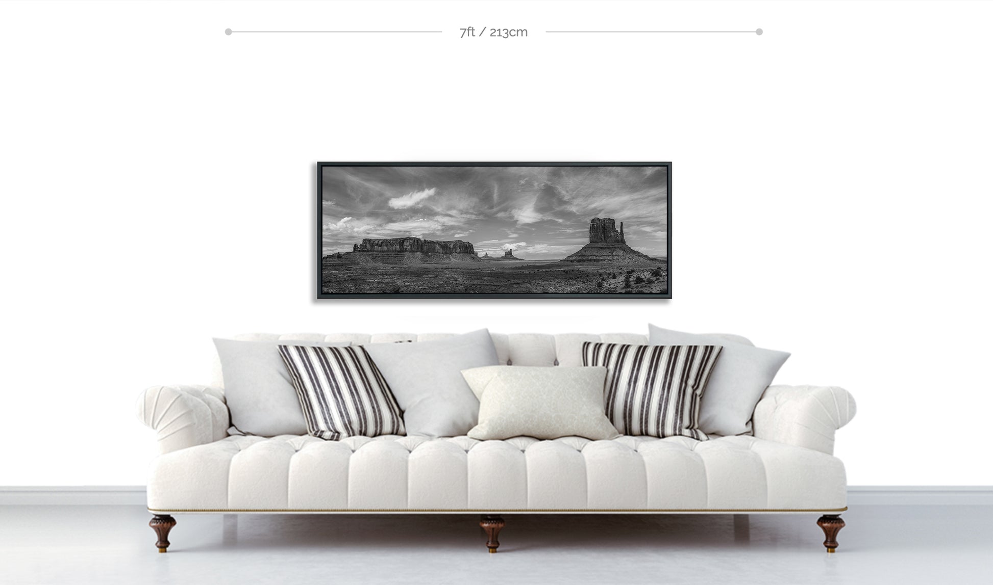 Monument Valley Limited Edition Fine Art Framed Print displayed hanging on white wall above white sofa with patterned cushions