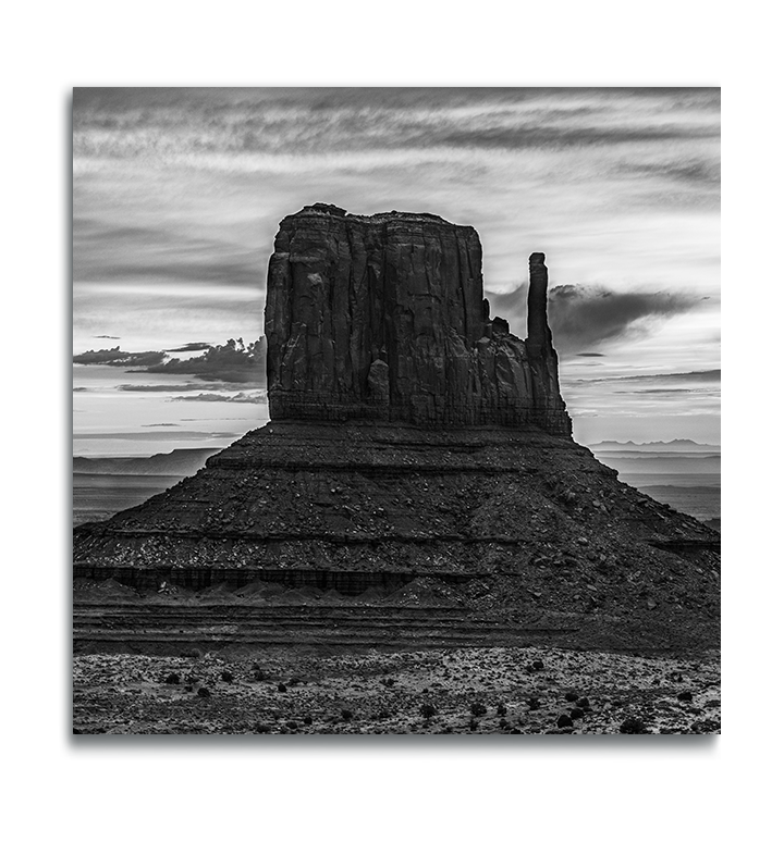 Monument Valley Square Metal Print classic desert butte against dramatically cloudy sky in black and white