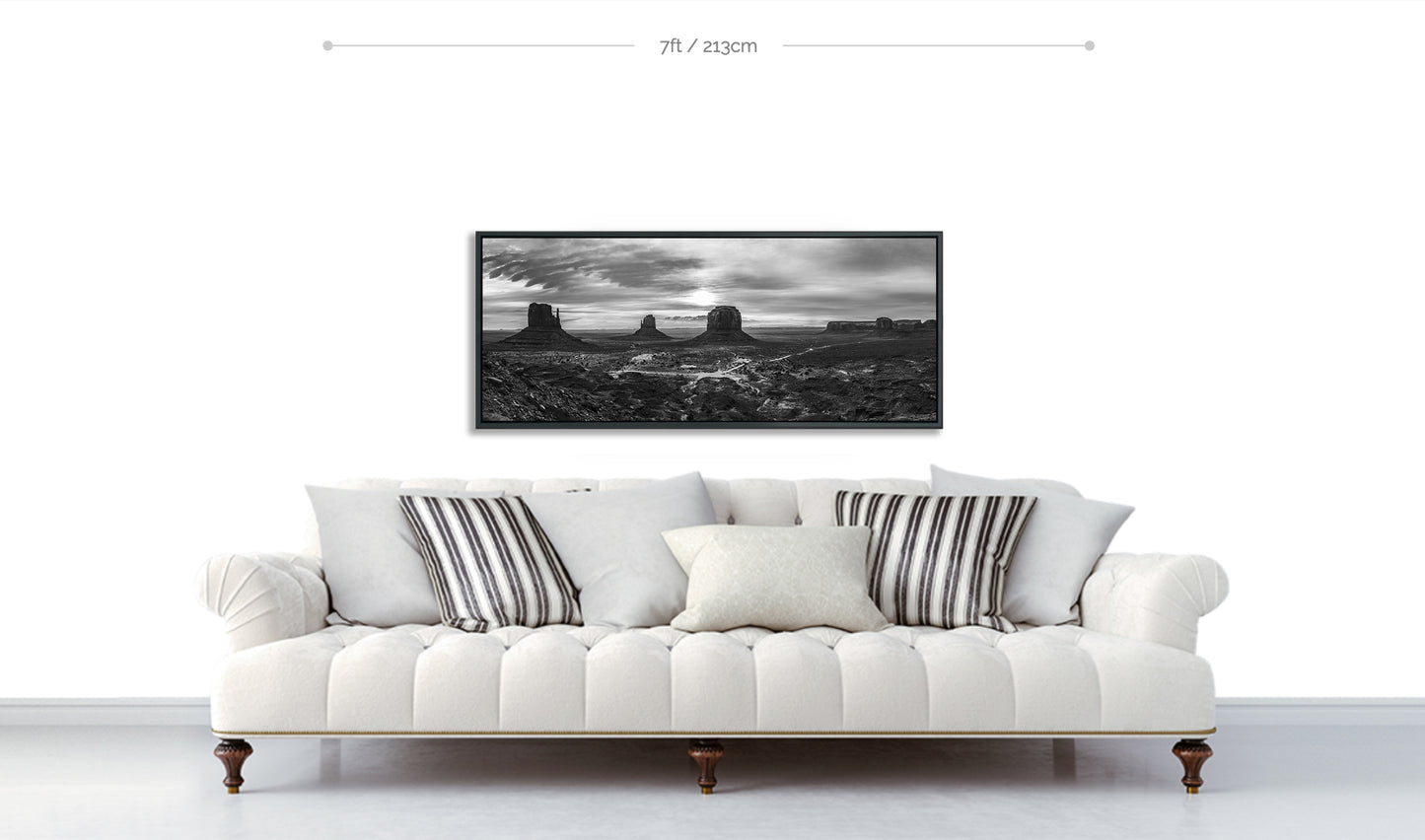 Monument Valley Fine Art Panoramic Metal black and white Print displayed above sofa with patterned pillows