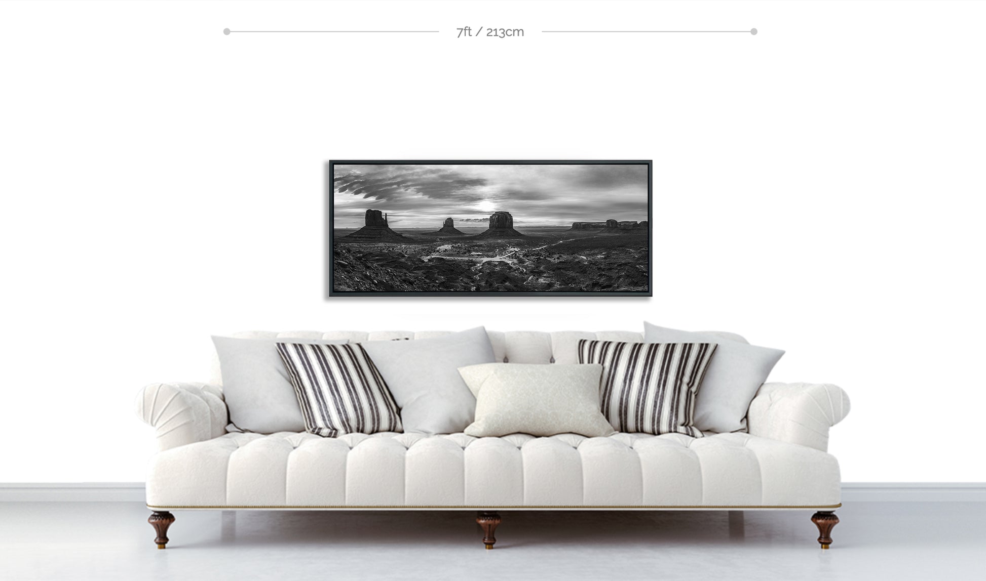 Monument Valley Fine Art Panoramic Metal black and white Print displayed above sofa with patterned pillows