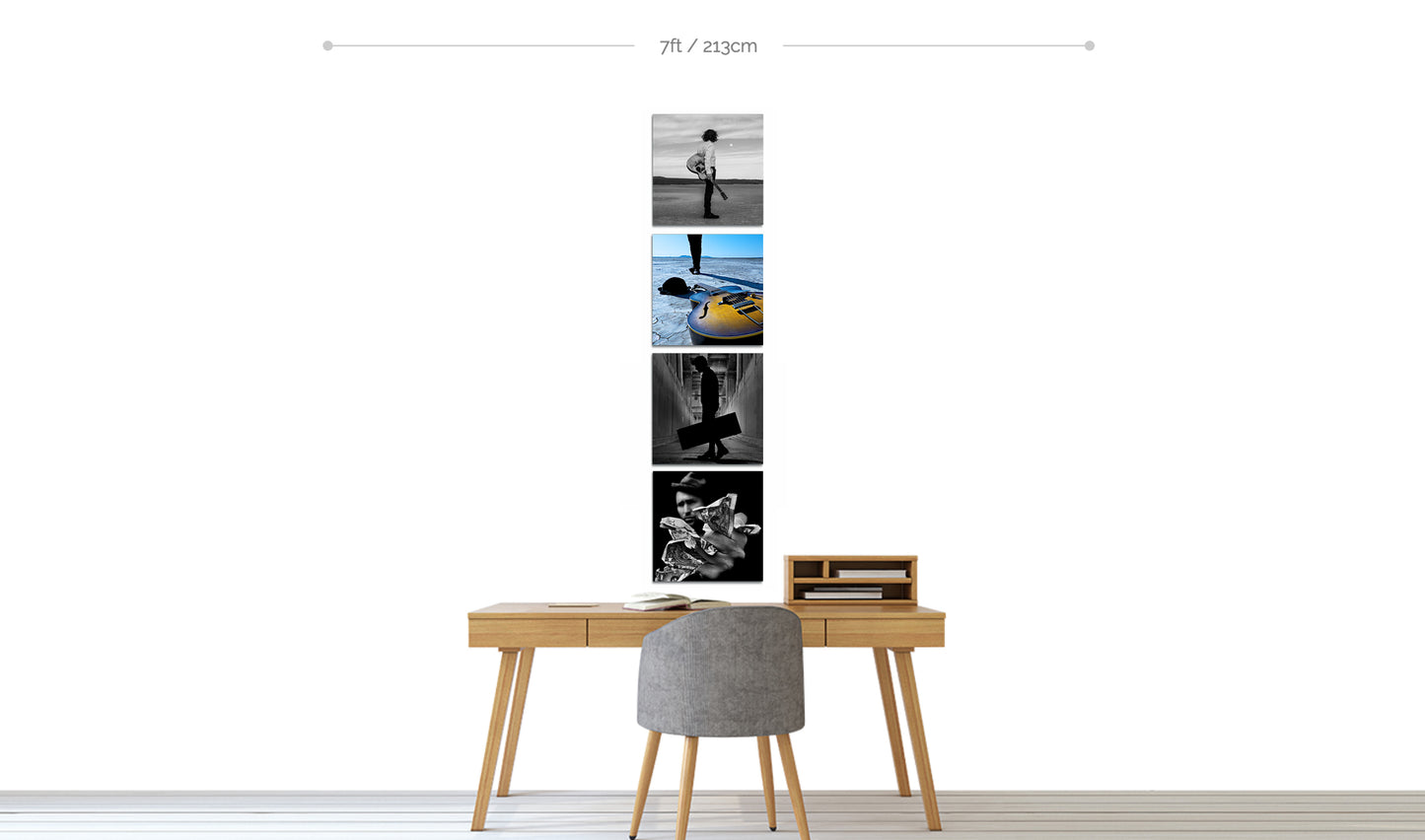 Set of four square metal fine art photographic prints displayed in vertical line on white wall above home office desk with chair