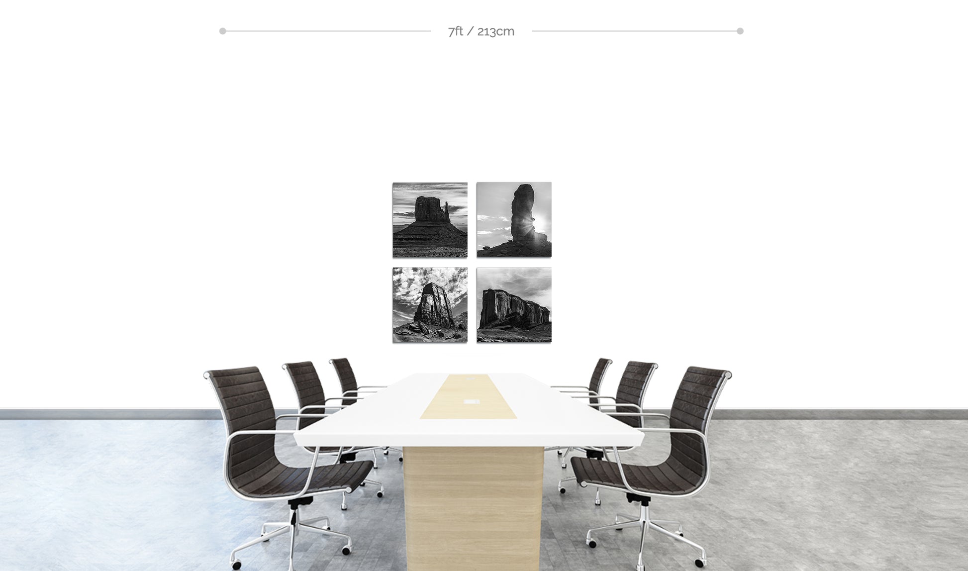 Monument Valley Square Metal Prints in black and white Set of 4 displayed in square formation on wall behind boardroom table with chairs