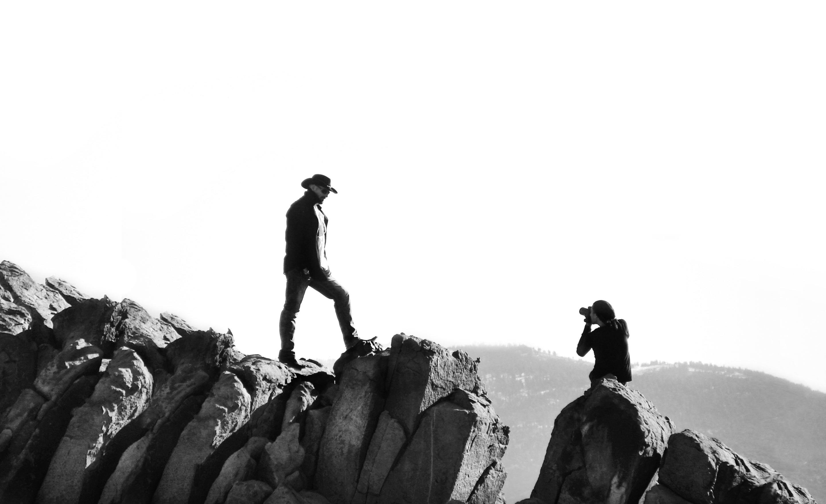 Fine Art Portrait Photograph behind the scenes black and white photo Mark Maryanovich photographing Todd Richard standing on ridge of rocks
