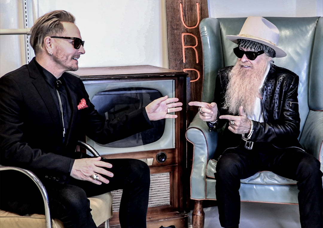 Matt Sorum with Billy F Gibbons Webisode One The Art of Giving Matt and Billy pointing at each other while seated