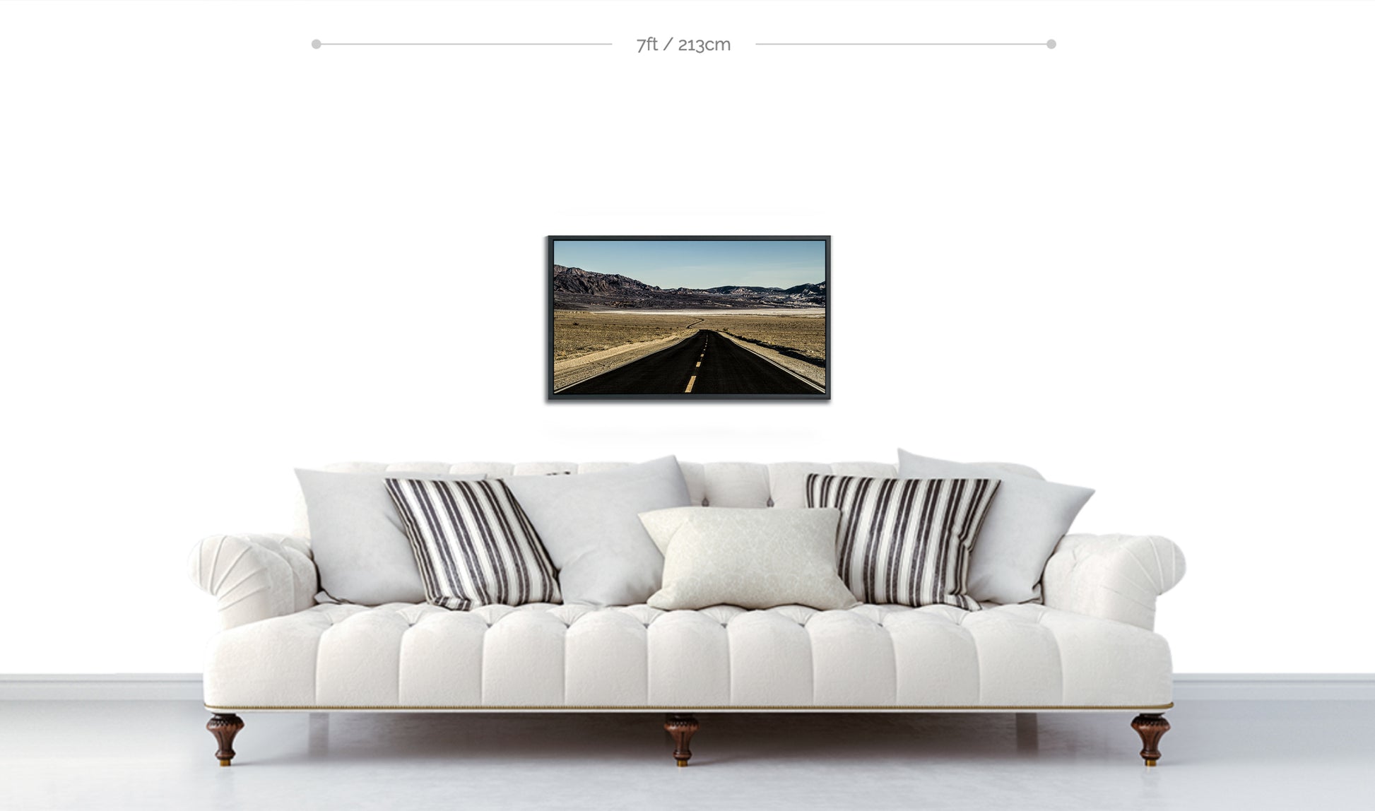 Color Fine Art Metal Photographic Print displayed above sofa black stretch of desert highway snaking into mountain ridge on white wall