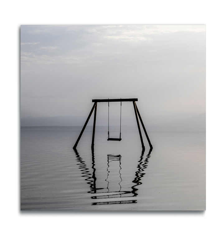 Fine Art color square print on metal swing set immersed in water in muted colors