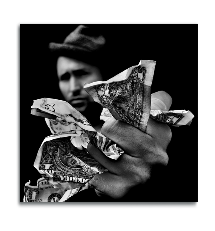 Fine Art Black and White square metal print man wearing hat out of focus in background holding money in his fist outstretched to camera in foreground